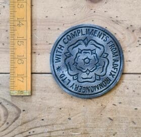 Coaster ADFIX WITH COMPLIMENTS Cast Antique Iron 100mm diameter